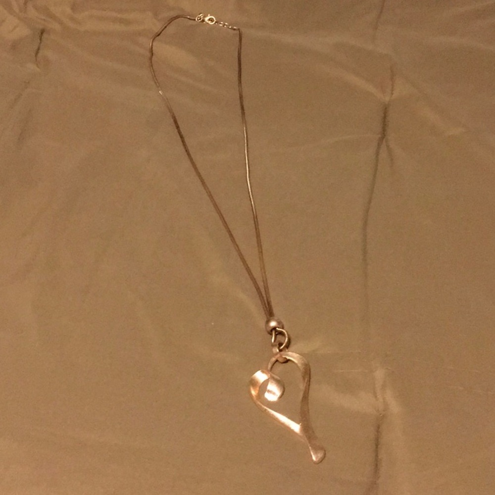 Long rose gold necklace with heart pendant.